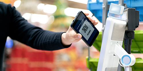 Person making a payment by tapping their phone on the POS machine