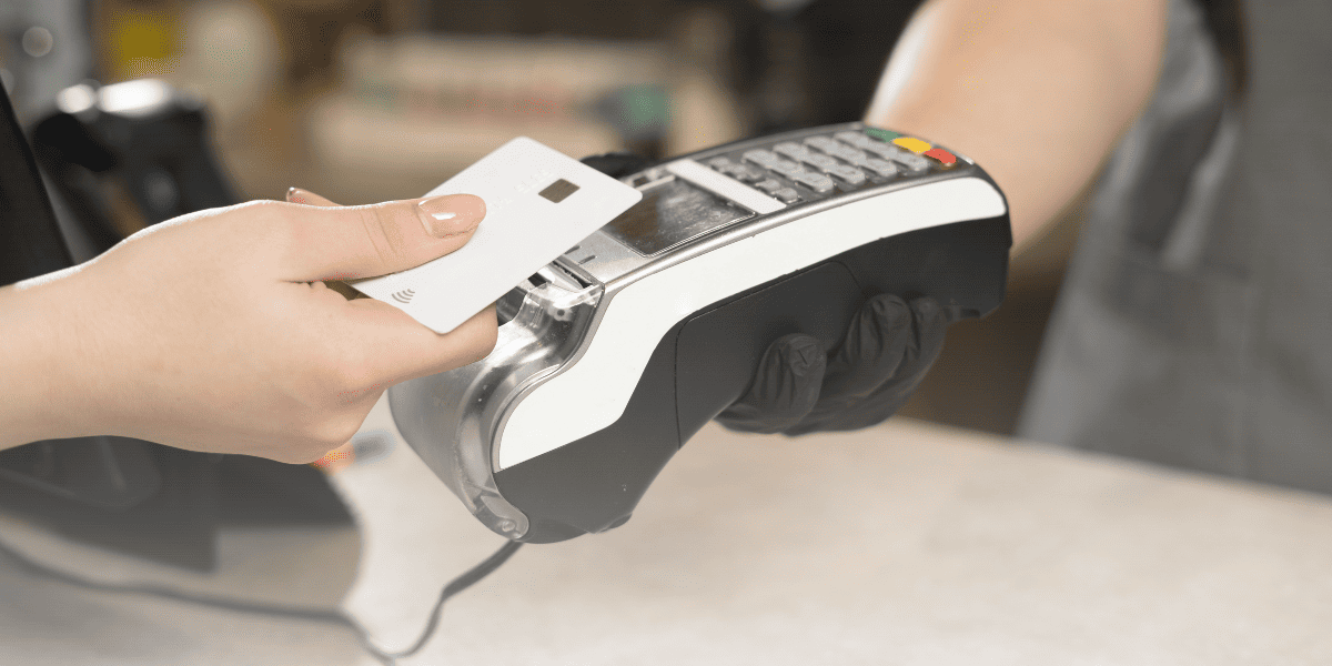 Business owner setting up a credit card machine, learning how to get a credit card machine for their business.
