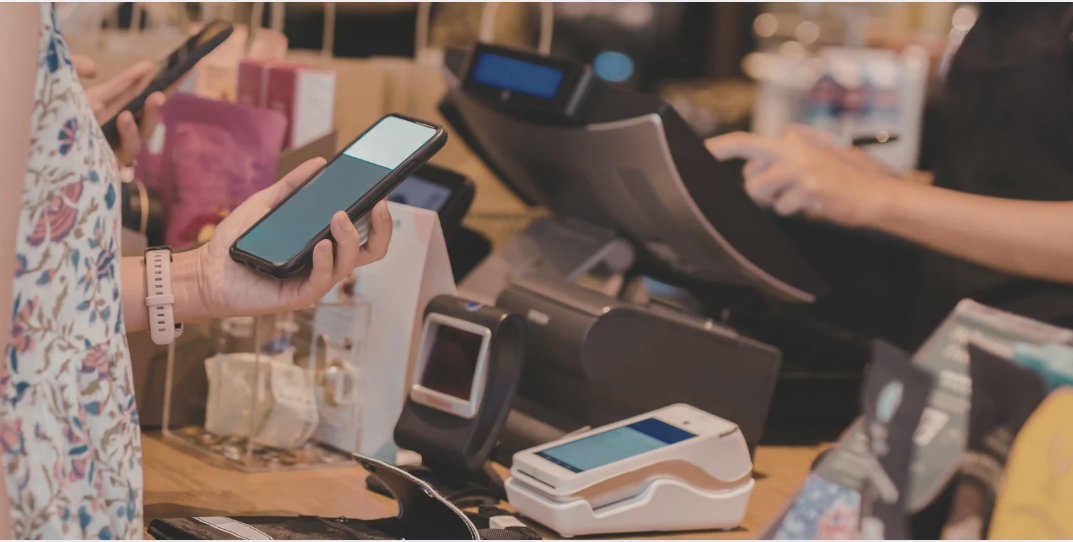 customer tapping phone on terminal