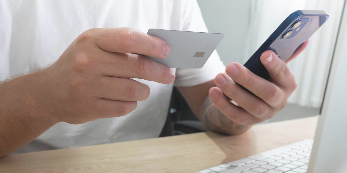 Customer entering credit card information on a smartphone to complete an online purchase.