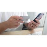 Customer entering credit card information on a smartphone to complete an online purchase.