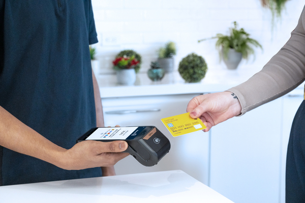 Customer making a card payment using a portable POS terminal