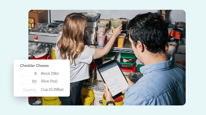 Restaurant staff using TouchBistro tablet integrated with Moneris to track inventory and manage food quantities in a storage area.