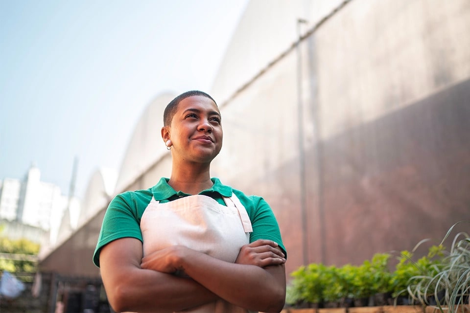 A garden centre business owner standing proud outside her store