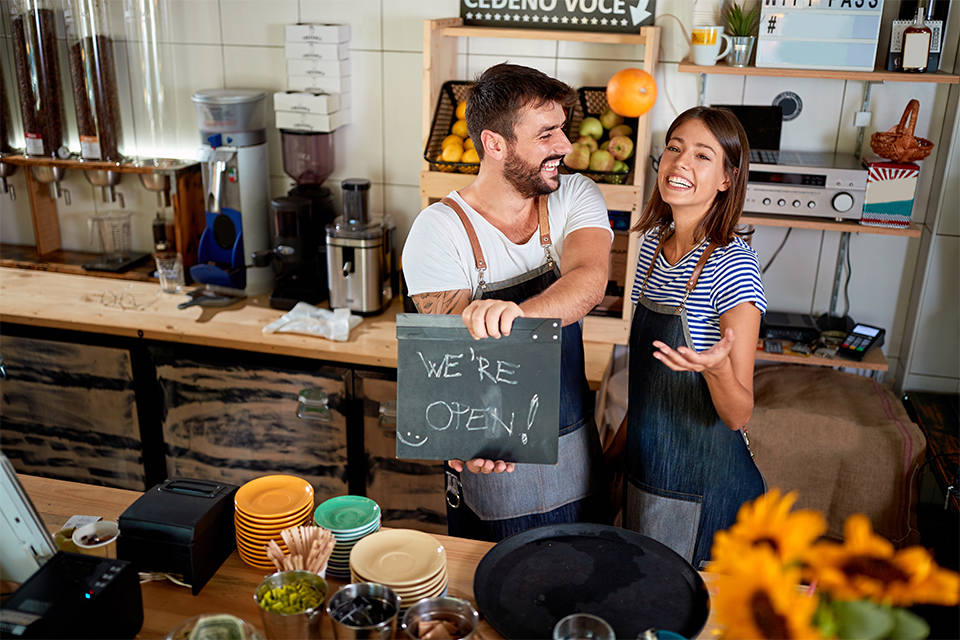Merchants holding a sign