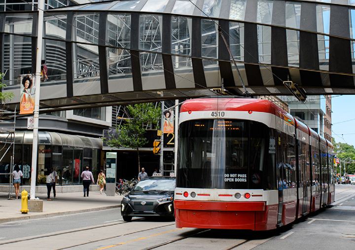A Toronto streetcar moves through the downtown core symbolizing the localization of consumer spending data.
