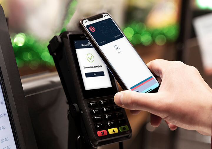 A person making a payment on a Moneris Core retail POS terminal, retail point of sale system, pos retail systems, retail point of sale systems