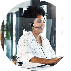 A woman working in sales smiling as she talks to a customer on her headset